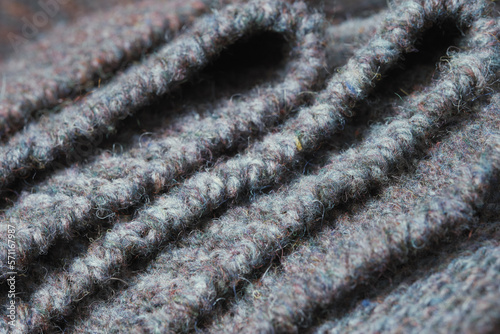Dark gray zigzag knitted fabric. Knitted texture.