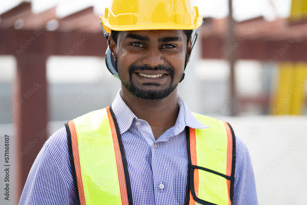 Portrait smiling India engineer man working at outdoor site work Portrait smiling India engineer man working at outdoor site work