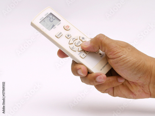human hand holding Ac remote photo