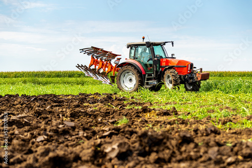 фотографія Tractor plowing and preparing stubble field for planting and cultivation of crop