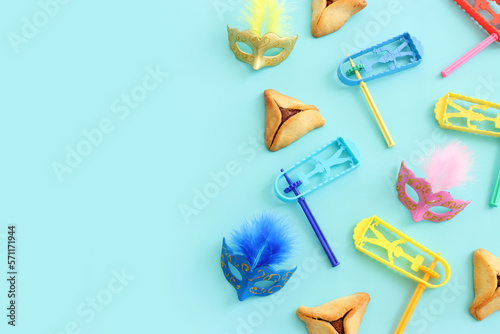 Purim celebration concept (jewish carnival holiday) over blue background. Top view, flat lay photo