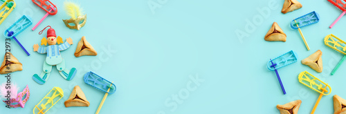 Purim celebration concept (jewish carnival holiday) over blue background. Top view, flat lay