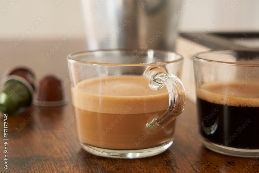 Cups of latte and black coffee with espresso capsules Cups of latte and black coffee with espresso capsules