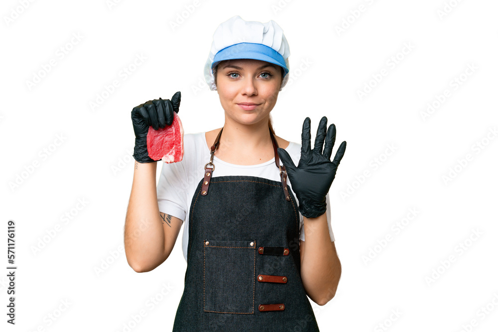 Butcher woman wearing an apron and serving fresh cut meat over isolated chroma key background counting five with fingers Butcher woman wearing an apron and serving fresh cut meat over isolated chroma key background counting five with fingers