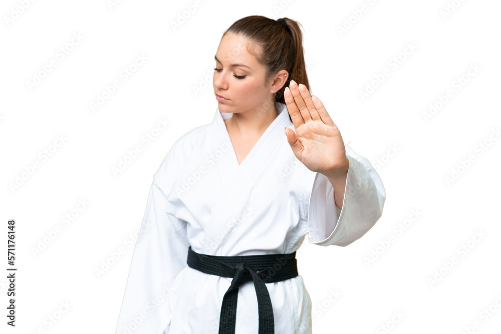 Young blonde woman doing karate over isolated chroma key background making stop gesture and disappointed Young blonde woman doing karate over isolated chroma key background making stop gesture and disappointed