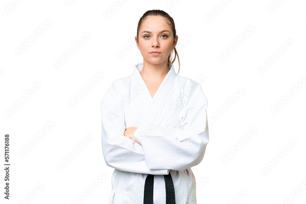 Young blonde woman over isolated chroma key background doing karate keeping the arms crossed Young blonde woman over isolated chroma key background doing karate keeping the arms crossed