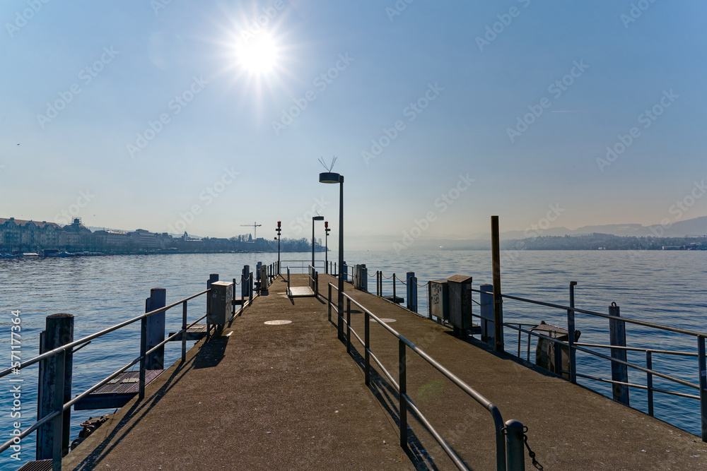 Scenic view of Lake Zürich with bright sun seen from pier at City of Zürich on a sunny winter day. Photo taken February 9th, 2023, Zurich, Switzerland.