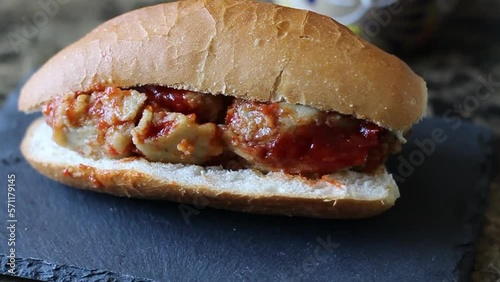 slow motion slider of tamale torta in red sauce. Mexican food. sandwich photo