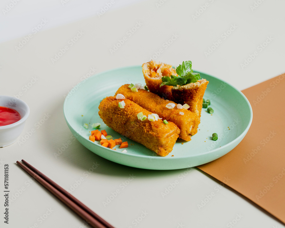 Rissole or Risol Sayur is a typical Indonesian snack served on a turquoise plate decorated with wartel and celery. Rissole or Risol Sayur is a typical Indonesian snack served on a turquoise plate decorated with wartel and celery.