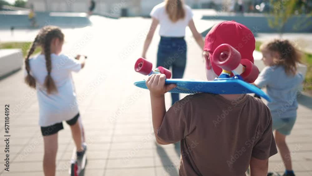 group of kids on playground with skateboard. group a team children go