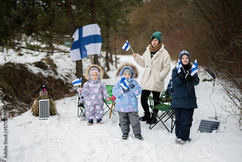 Finnish mother and children with Finland flags on a nice winter day. Nordic Scandinavian people. photo