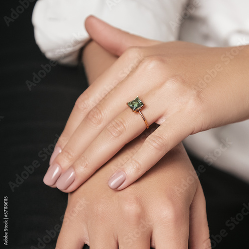 Woman Jewelery concept. Woman hands close up wearing rings, earrings and necklace modern accessories elegant life style.