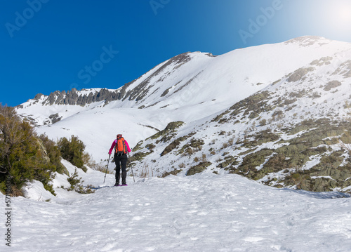 woman walking with snowshoes in the snowy mountains