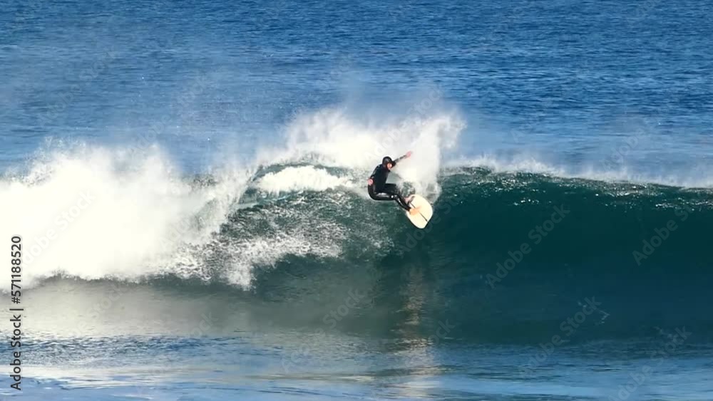 POV Surfer riding blue ocean wave carving powerful turn, surfing ocean lifestyle, extreme sports, slow motion mode. POV Surfer riding blue ocean wave carving powerful turn, surfing ocean lifestyle, extreme sports, slow motion mode.