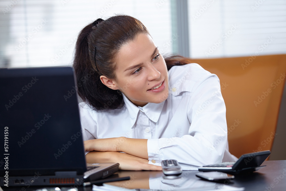 Young businesswoman sitting at workplace Young businesswoman sitting at workplace