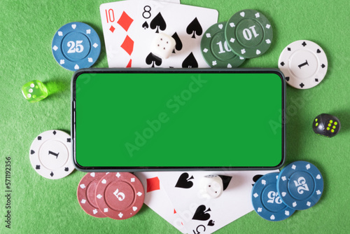 Mockup phone with chroma key and playing cards and poker chips in the casino