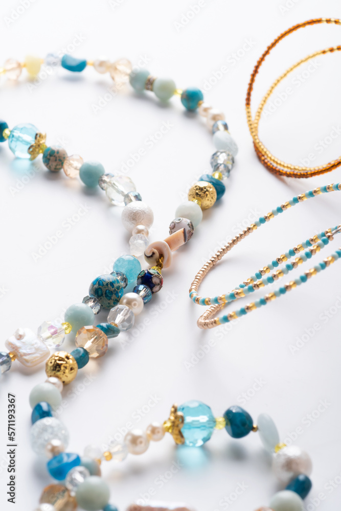author trend necklace with different beads demonstrated against white background. fashion and jewelry concept author trend necklace with different beads demonstrated against white background. fashion and jewelry concept