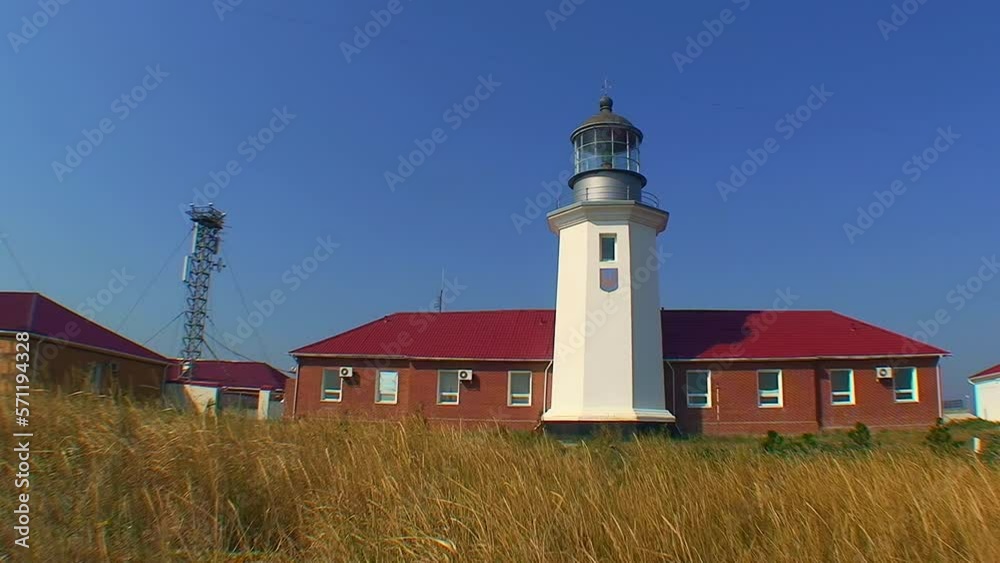 Snake Island lighthouse and lighthouse buildings, wide shot. Black Sea, Ukraine. Snake Island lighthouse and lighthouse buildings, wide shot. Black Sea, Ukraine.