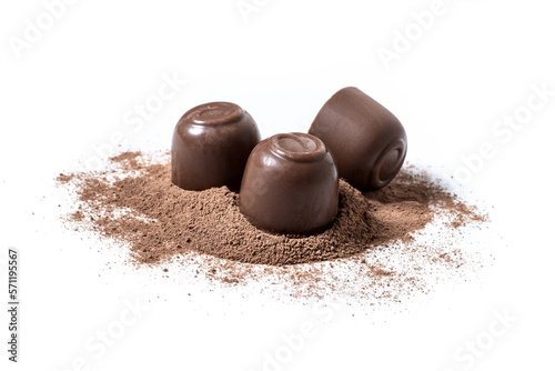 Chocolate bonbons and cocoa powder isolated on white background