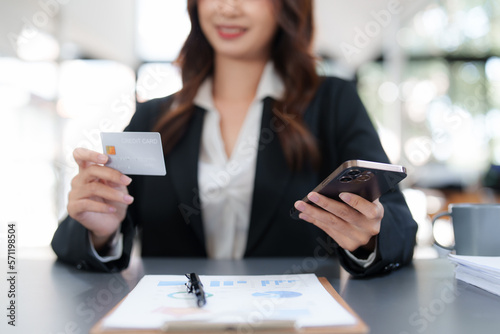 Woman makes a purchase on the smart phone with credit card, online payment, shopping online, e-commerce, internet banking concept