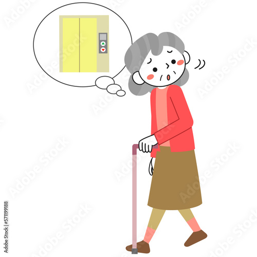 エレベーターを探しながら杖をついて歩くシニア女性