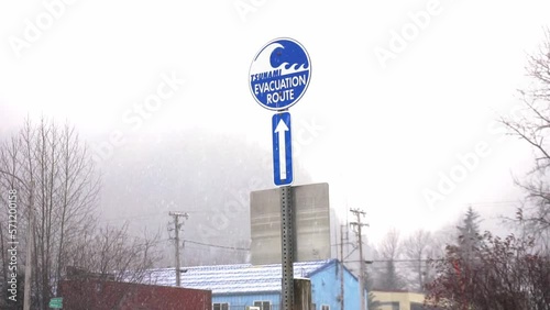 Tsunami evacuation route sign in Seward Alaska during a winter snowfall