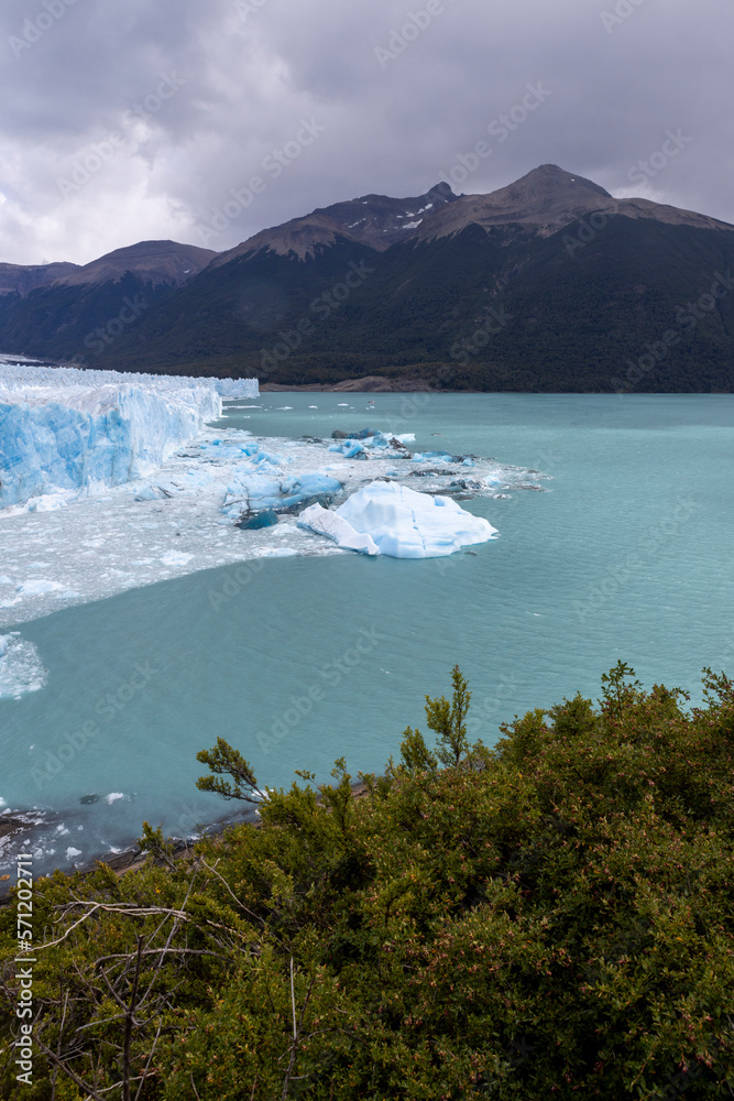 Deep blue and white chunks of ice of the famous glacier and natural sight Perito in the turquoise water of Lago Argentino in Patagonia, Argentina, South America 