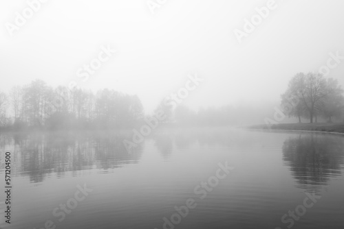 Germeringer See near Germering in Upper Bavaria. Landscape at the lake in the fog. Black and white shot. Foggy morning in nature. © Elly Miller