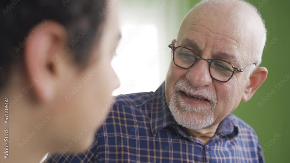 Knowledgeable grandfather gives advice to his grandson.
Old grandfather giving advice to his beautiful granddaughter.
