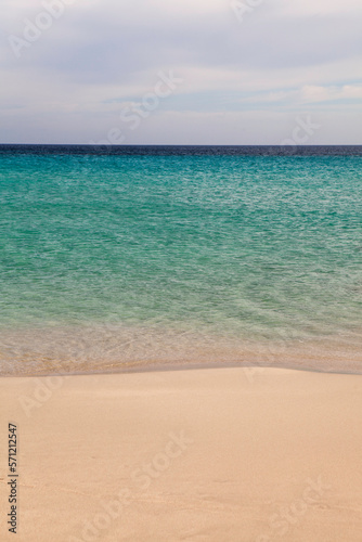 Close-up of sea sand wealth. Panoramic beach landscape. Inspire the skyline of a Caribbean pool. Cloudy sky © redchanka