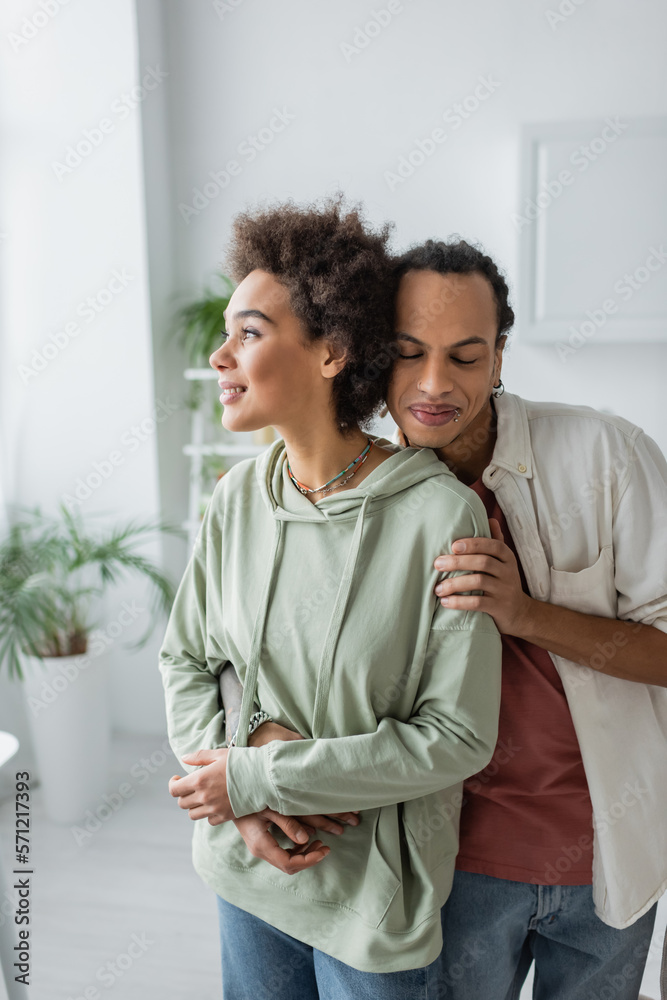 Smiling african american couple hugging at home. Smiling african american couple hugging at home.
