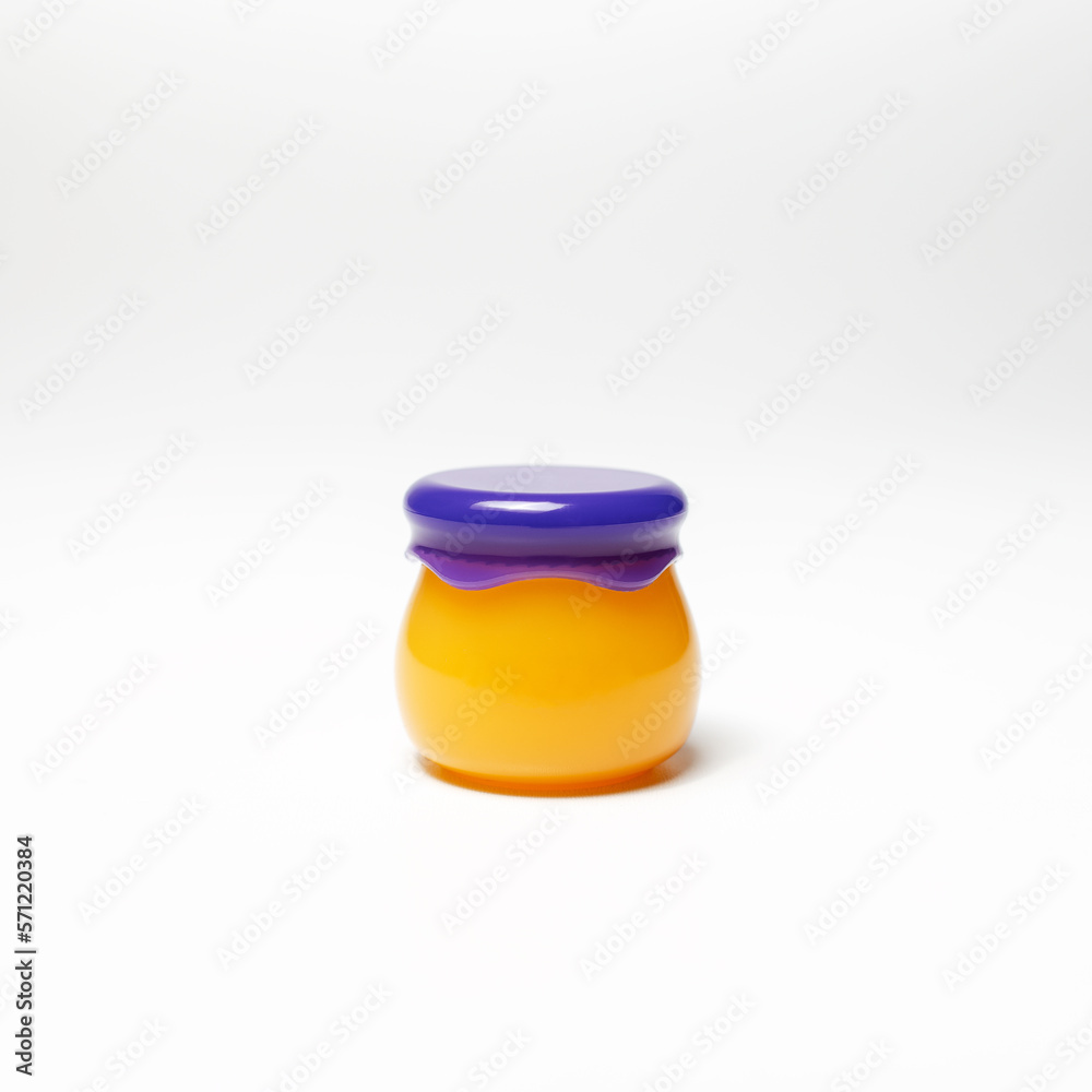 Close-up of small cosmetic jar of yellow color with purple cap isolated on white background. Close-up of small cosmetic jar of yellow color with purple cap isolated on white background.