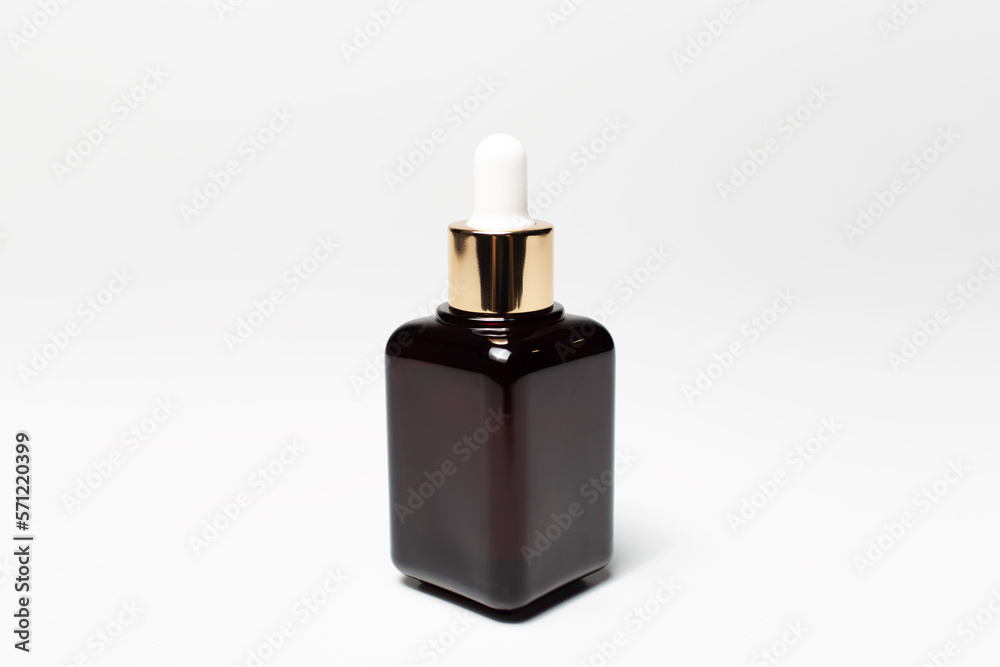 Close-up of closed glass small bottle with pipette isolated on white background. Close-up of closed glass small bottle with pipette isolated on white background.