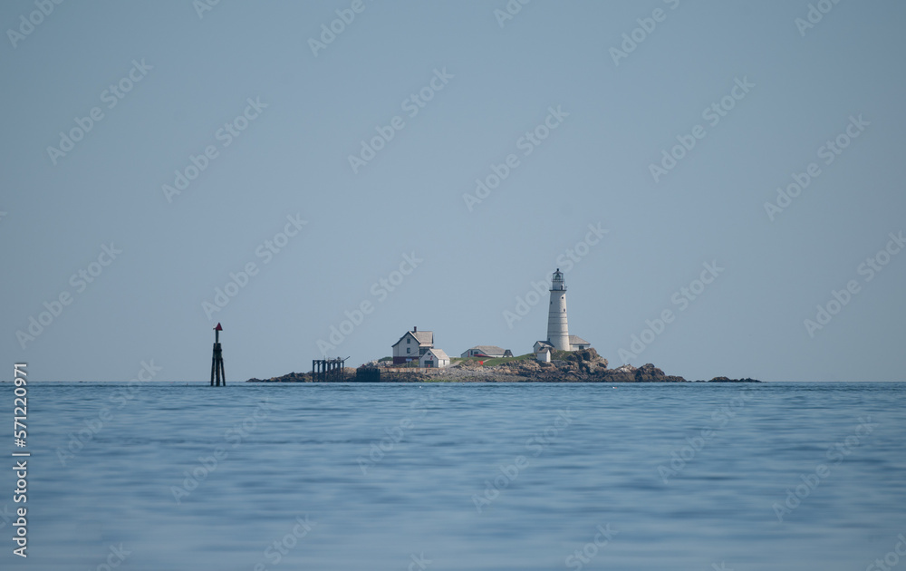 A lighthouse on an island in Boston Harbor in the summer A lighthouse on an island in Boston Harbor in the summer