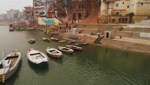 Aerial view of empty boats at Ganga Ghat in Banaras city at sunrise in slow motion high frame rate photo