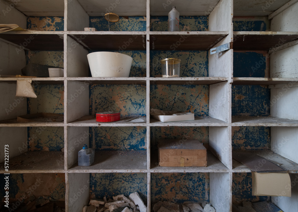 Bowls and other unique items on a shelf in an abandoned hospital Bowls and other unique items on a shelf in an abandoned hospital