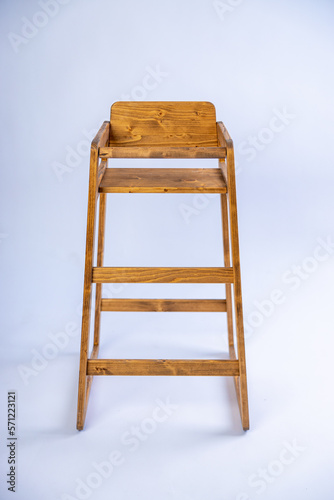 Wooden handmade high chair on white background in a studio