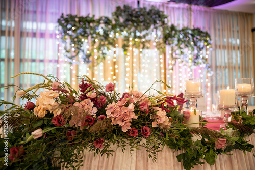Wedding flowers set up in a restaurant. A wedding colorful bouquet arrangement on the table with white table cloth. High quality photo