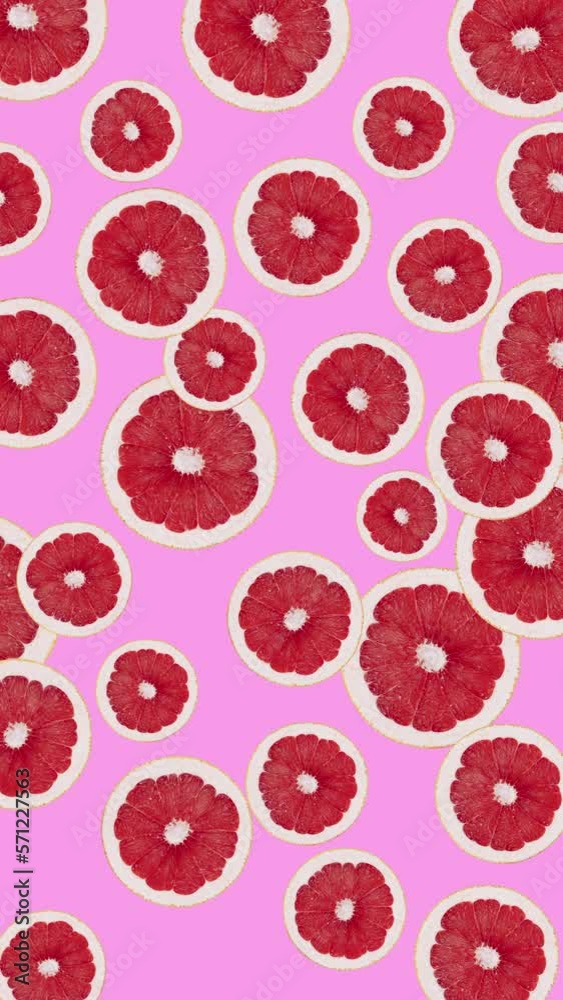 Minimal motion design - Grapefruit slices rotating at pink color background. Trendy colors and style graphics. Vertical eamless looping animation. Minimal motion design - Grapefruit slices rotating at pink color background. Trendy colors and style graphics. Vertical eamless looping animation.