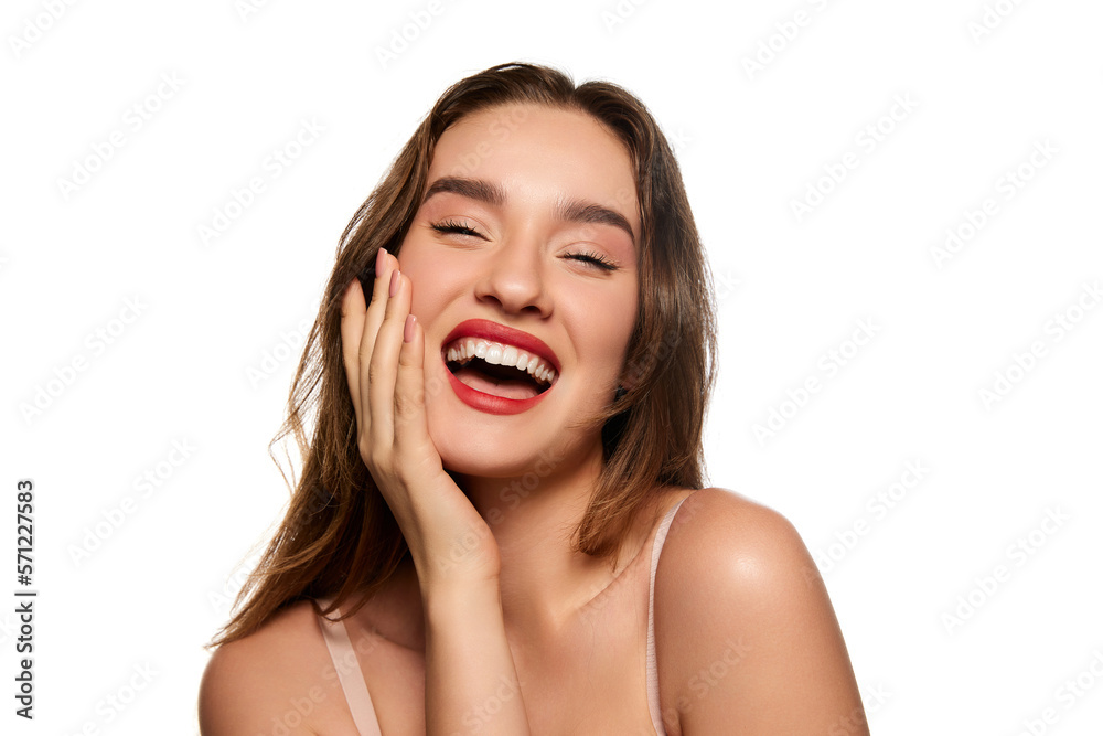 One beautiful brunette girl with well-kept healthy skin and white perfect teeth smiling, posing against white studio background. Concept of natural beauty, youth, health, wellness, femininity, make-up One beautiful brunette girl with well-kept healthy skin and white perfect teeth smiling, posing against white studio background. Concept of natural beauty, youth, health, wellness, femininity, make-up