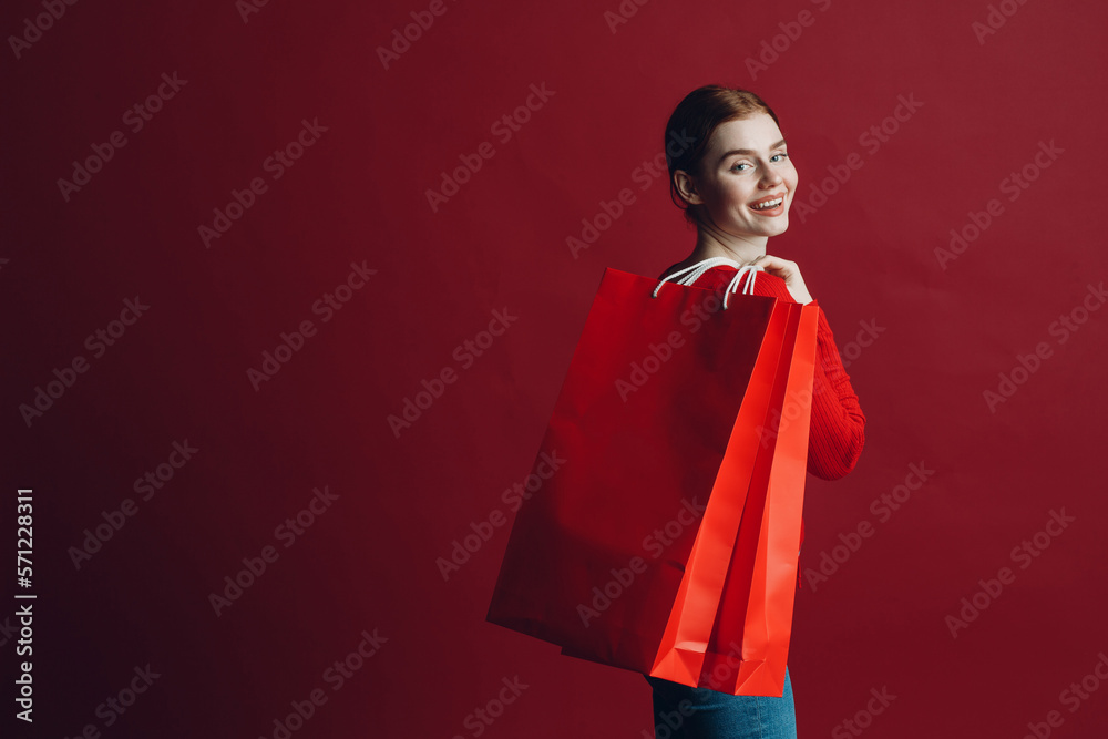 Pretty woman smilng portrait with paper red shopping bags. Black friday and sale concept Pretty woman smilng portrait with paper red shopping bags. Black friday and sale concept