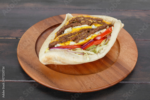 Sandwich triple steak maison dans une assiette sur une table en bois. Döner Kebab gros plan. photo