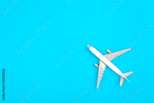 White plane, airplane on a blue background, flat lay, copy space.