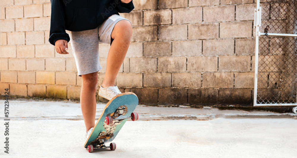 A boy skates in a hoodie and shorts with dog  Practice freestyle extreme Sports