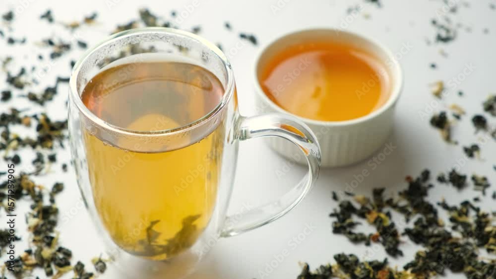 Add liquid lime honey to a glass cup of green tea. Add liquid lime honey to a glass cup of green tea.