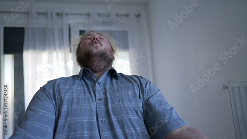 Overjoyed entrepreneur celebrating success in front of computer. Ecstatic joyful young man receives GREAT notification