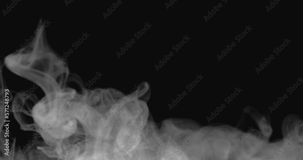 White smoke on a black background slowly spreads along the bottom White smoke on a black background slowly spreads along the bottom