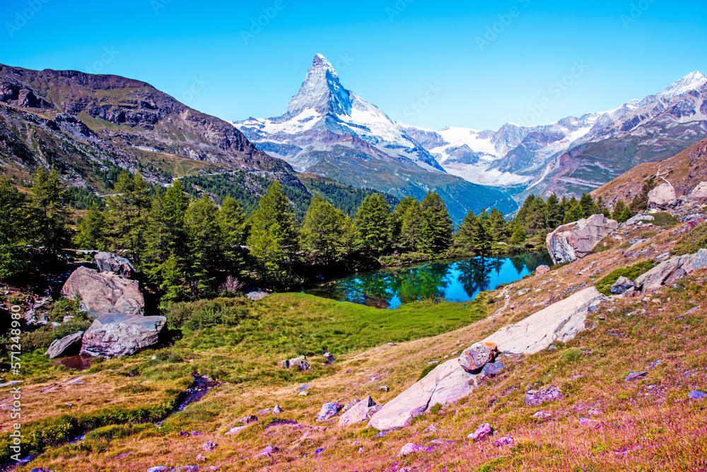 Magical beautiful autumn landscape with fir trees near lake on background Matterhorn in the Swiss Alps, near Zermatt, Switzerland. Amazing places. (Meditation, antistress - concept).