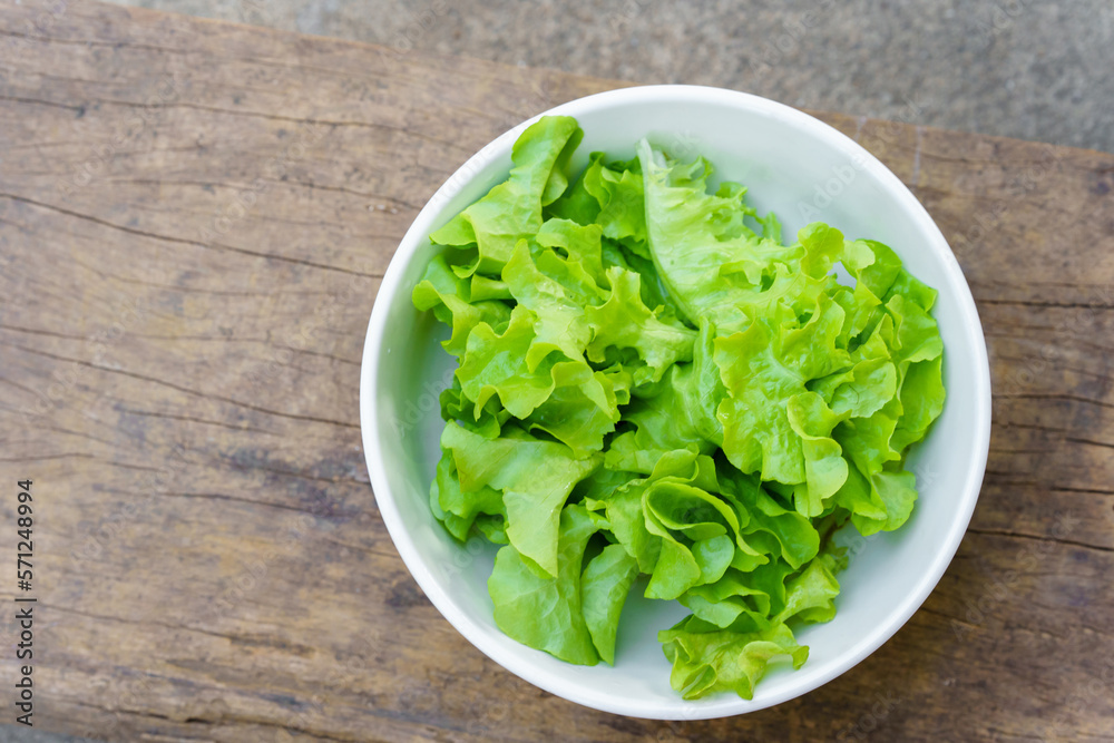 Leafy greens or lettuce in white bowls that are commonly used in salads or eaten fresh. Healthy food concept. Leafy greens or lettuce in white bowls that are commonly used in salads or eaten fresh. Healthy food concept.