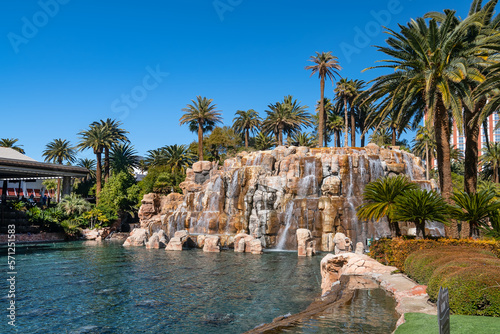 Canvas Print Waterfall and pond with palm trees next to the Mirage Hotel and Casino on the Strip in Las Vegas, Nevada